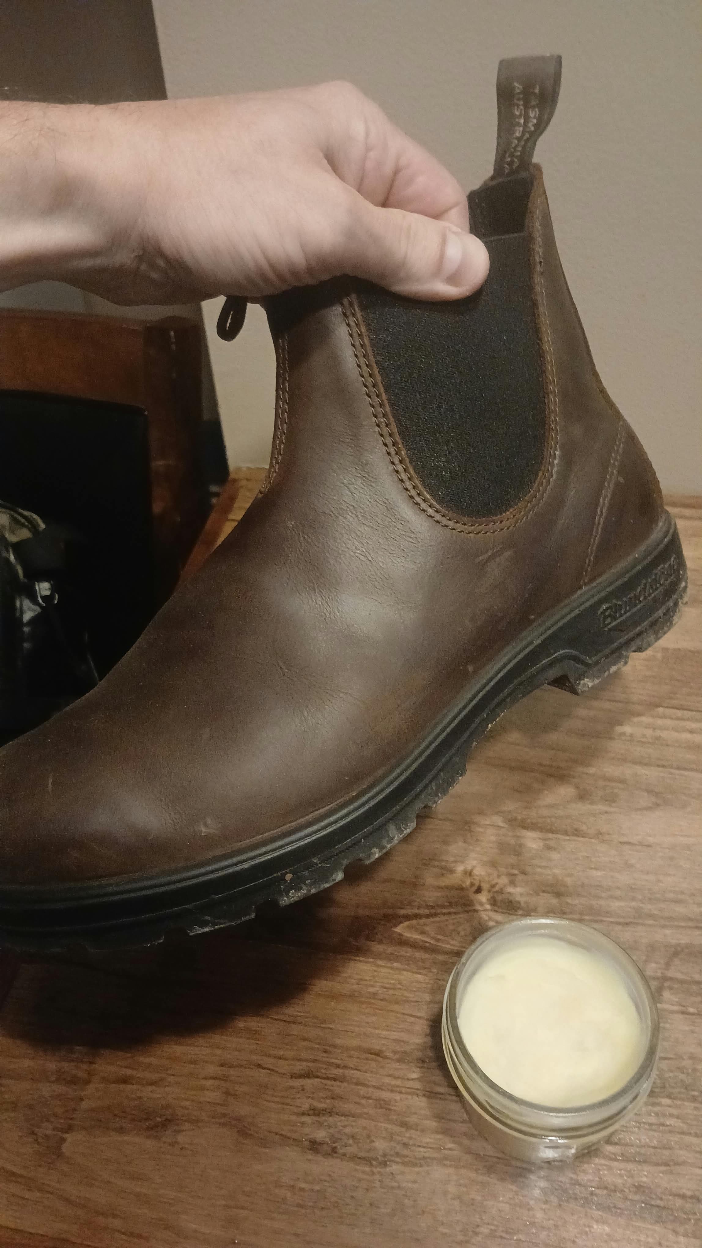 Crack Repair balm beside a worn leather boot